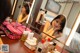 A woman sitting in front of a mirror in a hotel room.