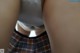 A close up of a person wearing a plaid skirt.