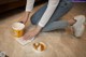 A woman sitting on the floor with a cup of coffee.